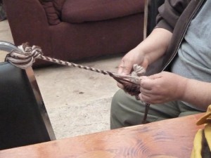 In the Culture Camp, yarn is used to create strings for thick mittens to protect against cold winters.